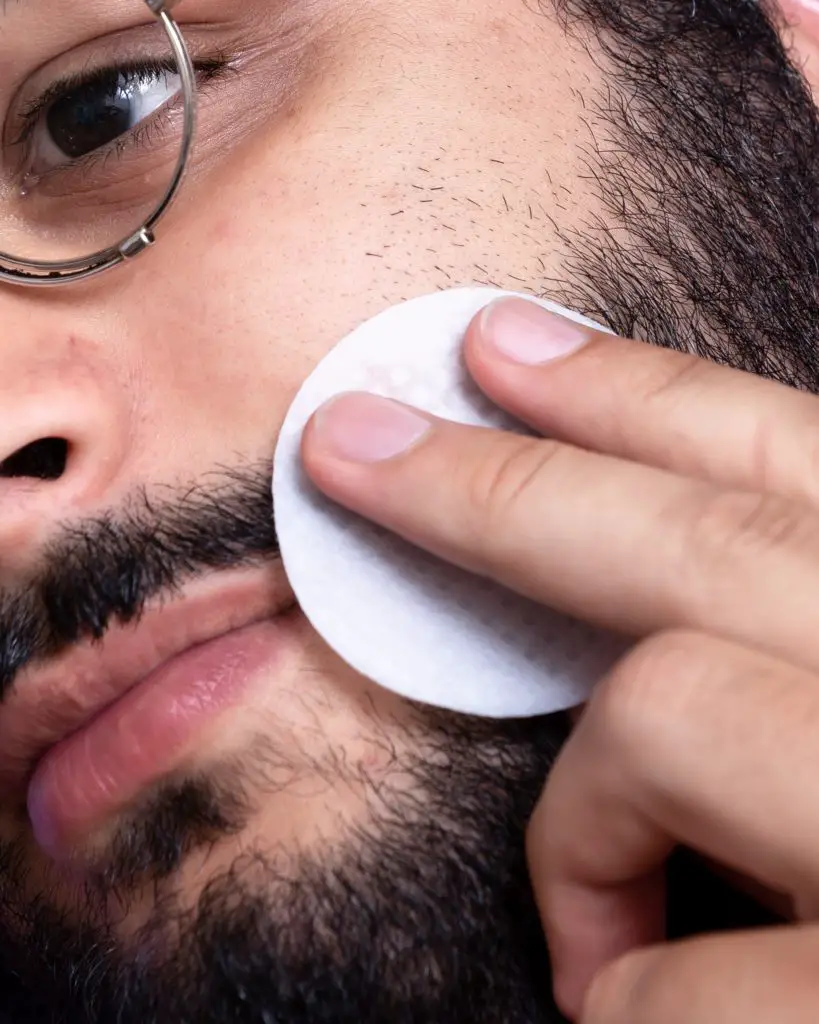 A man washing his beard with a cleansing pad. What can I do to keep my beard healthy? 